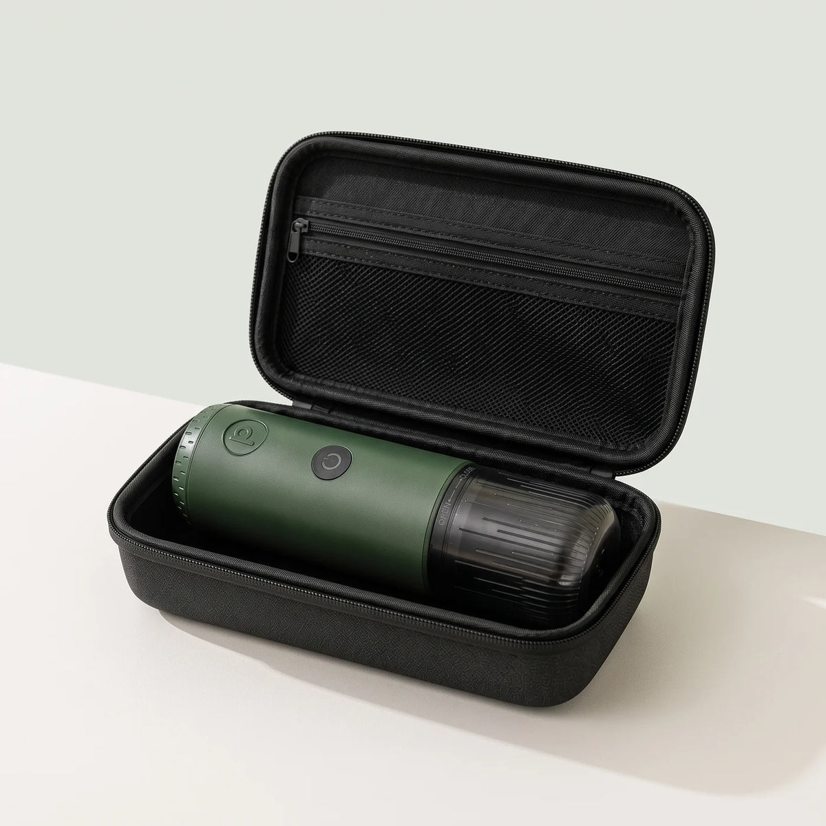 Open Travel Case with a Forest Green Origin portable espresso maker inside
